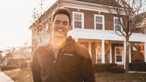 Smiling man outside home