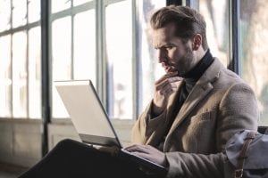 Man looking at computer in thought