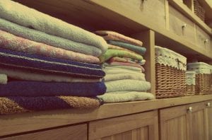 Stacks of towels on shelf in a closet