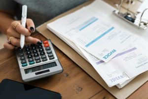 Person calculating finances on calculator