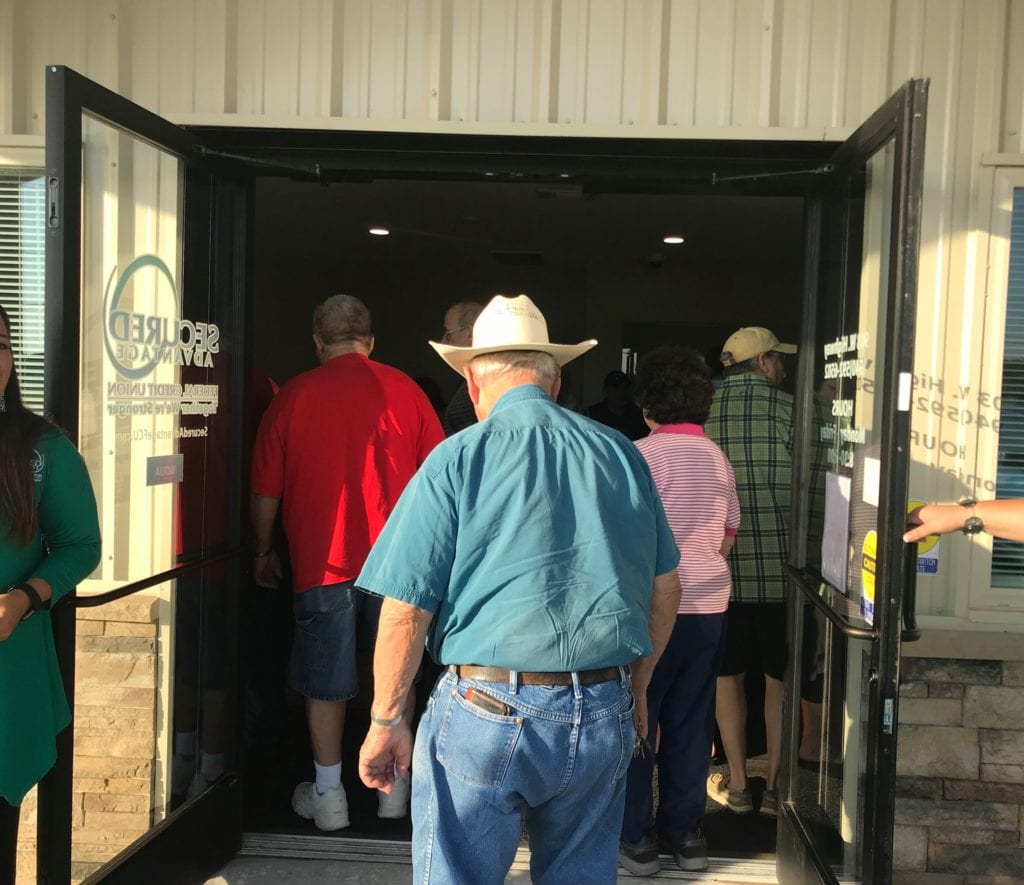 Man in a cowboy hat entering our new Iowa Park branch