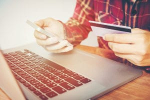 Man hand holding smartphone and credit card doing online banking. shopping online