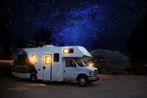 recreational vehicle parked with the nighsky in the background