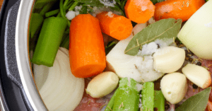 Various vegetables chopped and sitting in pot